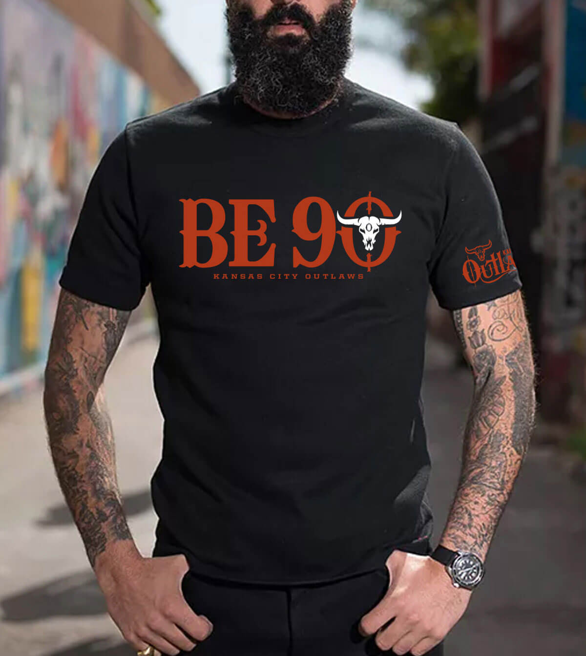 Front view of the black "Be 90" T-Shirt
